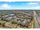 High angle view of community, street, lush greenery, pool, tennis courts, and parking areas at 782 Village Lake N Ter # 107, St Petersburg, FL 33716