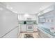 Bright kitchen with white cabinets and appliances at 7871 Sailboat Key S Blvd # 106, South Pasadena, FL 33707