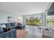 Relaxing living room boasts sectional sofa, large window with scenic views, and wood floors at 7871 Sailboat Key S Blvd # 106, South Pasadena, FL 33707