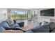 Spacious living room with sectional sofa, large window, and water views at 7871 Sailboat Key S Blvd # 106, South Pasadena, FL 33707