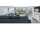 Spacious living room featuring a sectional sofa and large window with water views at 7871 Sailboat Key S Blvd # 106, South Pasadena, FL 33707