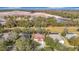 An aerial perspective showcasing a house nestled among trees near a developing area at 16829 Midsummer Ln, Spring Hill, FL 34610