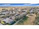 Elevated view of a neighborhood with homes, trees, and a walking path at 16829 Midsummer Ln, Spring Hill, FL 34610