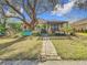 Backyard view of the home showing the patio, pergola, and landscaping at 16829 Midsummer Ln, Spring Hill, FL 34610