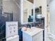 Modern bathroom with dark marble tile, white vanity, and backlit mirror at 16829 Midsummer Ln, Spring Hill, FL 34610