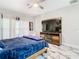 Inviting bedroom with wooden furniture, a ceiling fan, and a cozy sitting area at 16829 Midsummer Ln, Spring Hill, FL 34610