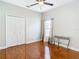 Empty bedroom with wood floors, white closet doors, a window, and a ceiling fan at 16829 Midsummer Ln, Spring Hill, FL 34610