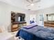 Comfortable bedroom featuring wood furniture, a ceiling fan, and access to the ensuite at 16829 Midsummer Ln, Spring Hill, FL 34610