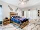 Cozy bedroom with wooden furniture, a ceiling fan, and decorated wing accents at 16829 Midsummer Ln, Spring Hill, FL 34610