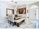 Stylish dining area with unique artwork, a wooden table, and marble flooring at 16829 Midsummer Ln, Spring Hill, FL 34610