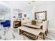Modern dining room featuring a wooden table, white chairs, and decorative mirror at 16829 Midsummer Ln, Spring Hill, FL 34610