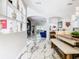 Dining area with a unique wooden table, white chairs, and marble floors at 16829 Midsummer Ln, Spring Hill, FL 34610