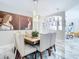 Dining room with a wooden table, white chairs, and built-in shelving at 16829 Midsummer Ln, Spring Hill, FL 34610