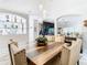 Modern dining space with a large wooden table, white chairs, and unique art pieces at 16829 Midsummer Ln, Spring Hill, FL 34610