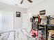 This game room features arcade games, a ceiling fan, and double doors at 16829 Midsummer Ln, Spring Hill, FL 34610