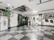 Garage with overhead storage, checkered floor, and organization system at 16829 Midsummer Ln, Spring Hill, FL 34610