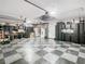 Spacious garage with checkered floor, storage cabinets, and workbench area at 16829 Midsummer Ln, Spring Hill, FL 34610