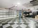 Garage interior with checkered flooring, storage, and overhead door at 16829 Midsummer Ln, Spring Hill, FL 34610