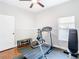 Home gym with treadmill, exercise bike, and other fitness equipment at 16829 Midsummer Ln, Spring Hill, FL 34610