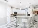 Modern kitchen with white cabinets, granite countertops, breakfast bar, and stainless steel appliances at 16829 Midsummer Ln, Spring Hill, FL 34610