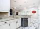 White kitchen with granite countertops, stainless steel appliances, and a breakfast bar at 16829 Midsummer Ln, Spring Hill, FL 34610