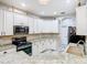 Bright kitchen featuring white cabinetry, stainless steel appliances, and granite countertops at 16829 Midsummer Ln, Spring Hill, FL 34610