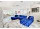 Open-concept living room with blue velvet sectional sofa and view of adjacent rooms at 16829 Midsummer Ln, Spring Hill, FL 34610