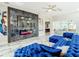 Large living area featuring a blue sectional sofa, marble tile floor, and a modern fireplace at 16829 Midsummer Ln, Spring Hill, FL 34610