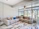 Cozy living space with ample natural light, sectional sofa, and marble-look tile floor at 16829 Midsummer Ln, Spring Hill, FL 34610
