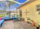 Inviting screened patio with comfortable seating, decorative accents, and a view of the backyard at 16829 Midsummer Ln, Spring Hill, FL 34610