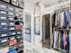 Custom walk-in closet with shoe storage, clothing racks, and a safe at 16829 Midsummer Ln, Spring Hill, FL 34610