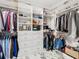 Large walk-in closet with built-in shelves, drawers, and ample hanging space at 16829 Midsummer Ln, Spring Hill, FL 34610