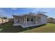 Covered patio in backyard, perfect for entertaining or relaxing outdoors, with a view of the fenced perimeter at 1722 St Croix Dr, Clearwater, FL 33759