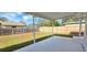 Large grassy backyard, covered patio, and wood privacy fence at 1722 St Croix Dr, Clearwater, FL 33759