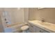 Clean bathroom with white tile, a single sink vanity, and a bathtub at 1722 St Croix Dr, Clearwater, FL 33759