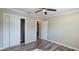 Bedroom with wood-look floors, ceiling fan, and closet at 1722 St Croix Dr, Clearwater, FL 33759