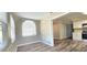 Bright dining nook featuring a large window with blinds, wood look flooring, and easy access to the kitchen at 1722 St Croix Dr, Clearwater, FL 33759
