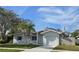 Charming single-story home featuring a well-maintained yard, attached garage, and inviting front entrance at 1722 St Croix Dr, Clearwater, FL 33759