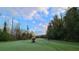 Golf course with a golf cart and player on the green at 1722 St Croix Dr, Clearwater, FL 33759