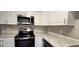 Functional kitchen featuring stainless steel appliances, ample counter space, and white cabinets for a modern feel at 1722 St Croix Dr, Clearwater, FL 33759