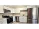 Modern kitchen featuring stainless steel appliances, white cabinets, and light countertops, offering a clean aesthetic at 1722 St Croix Dr, Clearwater, FL 33759