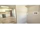 The laundry room opens to a kitchen with stainless appliances, white cabinets, and granite counters at 1722 St Croix Dr, Clearwater, FL 33759