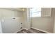 Functional laundry room with shelving, window and new wood-look floors at 1722 St Croix Dr, Clearwater, FL 33759