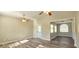 Open living room featuring wood-look floors, ceiling fan, and abundant natural light at 1722 St Croix Dr, Clearwater, FL 33759
