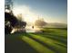 Misty sunrise over a serene golf course with a flag at 36750 Us Highway 19 N # 06110, Palm Harbor, FL 34684
