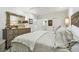Large primary bedroom with ensuite bathroom, wooden dresser, ceiling fan, and ample natural light at 36750 Us Highway 19 N # 06110, Palm Harbor, FL 34684