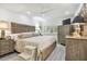 Elegant main bedroom with wooden headboard, matching dresser, and ceiling fan at 36750 Us Highway 19 N # 06110, Palm Harbor, FL 34684