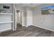 Bedroom with wood-look floors, TV, and built-in shelves at 4045 Bramblewood Loop, Spring Hill, FL 34609