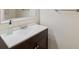Compact bathroom with white countertop, dark wood vanity, and a framed mirror at 6321 Newtown Cir # 21B4, Tampa, FL 33615