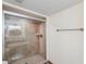 Modern bathroom featuring a glass-enclosed walk-in shower and marble-tiled walls at 6321 Newtown Cir # 21B4, Tampa, FL 33615